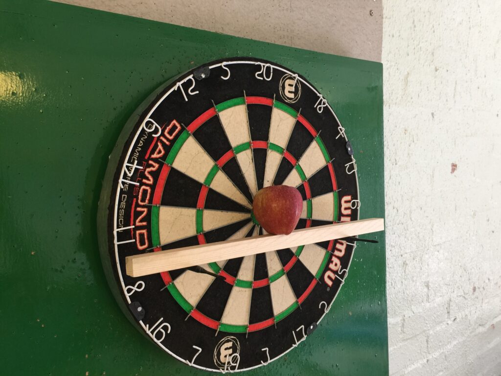 Apple in front of the dartboard